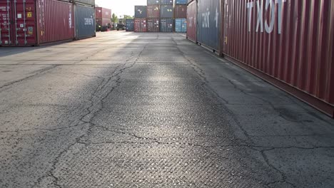industrial container yard with sunlit pathway: a welcoming view of shipping containers creating a unique urban landscape