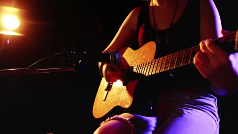 Woman-singing-song-while-playing-electric-guitar-4k