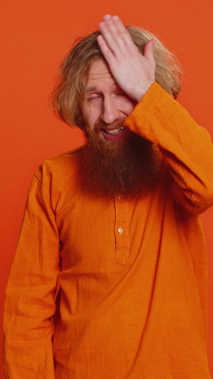Caucasian young man making face palm gesture feeling bored disappointed in result bad news quarrel