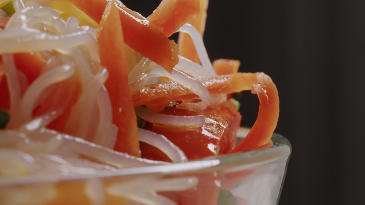 Glass noodles salad with meat and carrots fermented close up asian chinese traditional food.