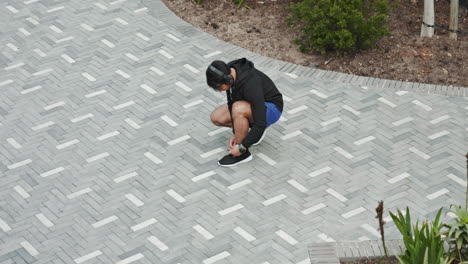 man tying his shoelace before a run