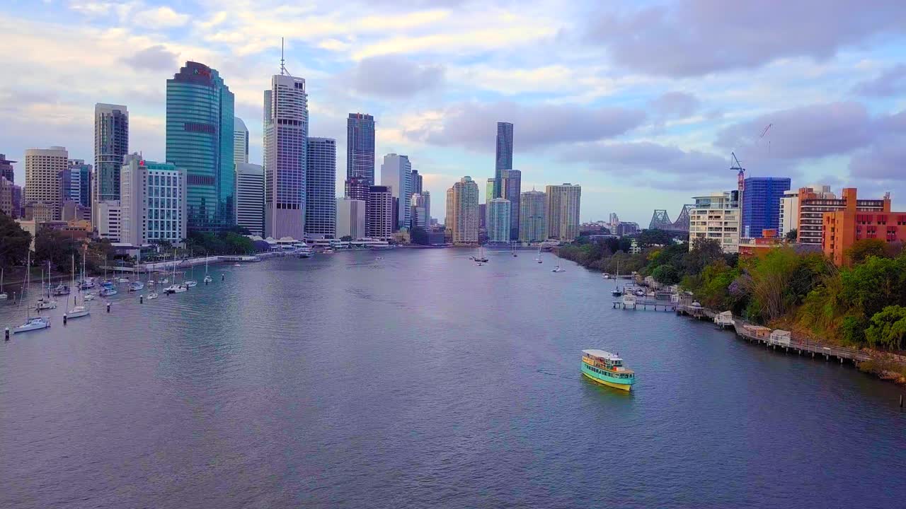 Aerial view of a city ferry with high buildings in the background.