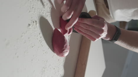 cutting beetroot pasta dough into pieces