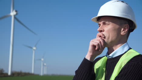 engineer inspecting wind turbines