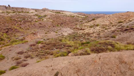 Canyon-rock-formation-and-mountains-next-to-sea