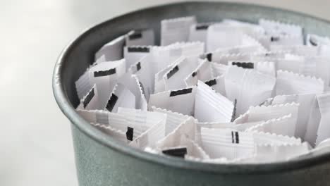 close up of sugar packets in a metal bucket