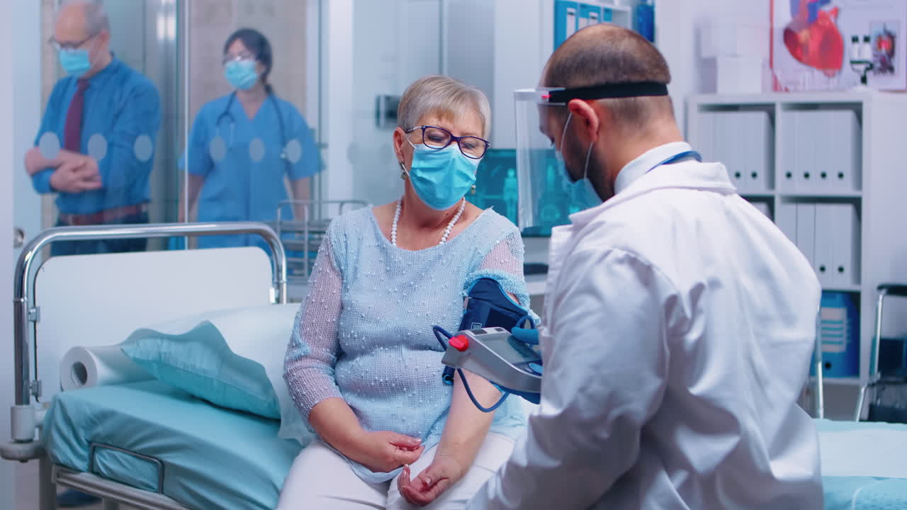 Measuring old retired lady blood pressure