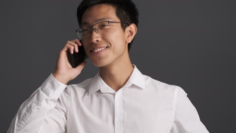 happy asian man calling on smartphone.