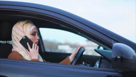 woman driving a car while talking on the phone