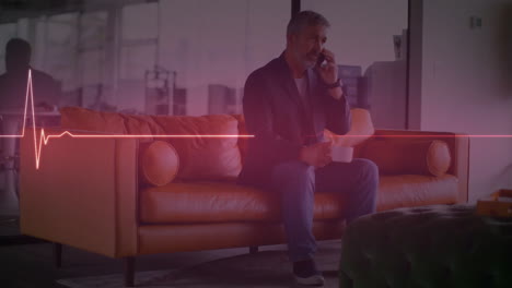 animation of heart rate monitor over caucasian senior man talking on smartphone at office