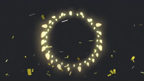 confetti falling over fairy lights forming a circle against black background