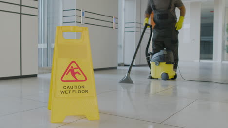 Camera-Focuses-Wet-Floor-Warning-Sign