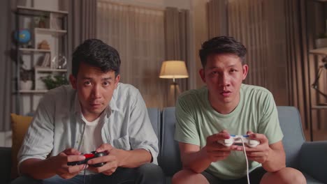 young asian friends playing video games at home and disappointed