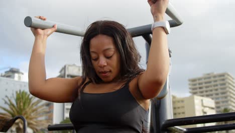 Disabled-woman-exercising-with-shoulder-press-machine-4k