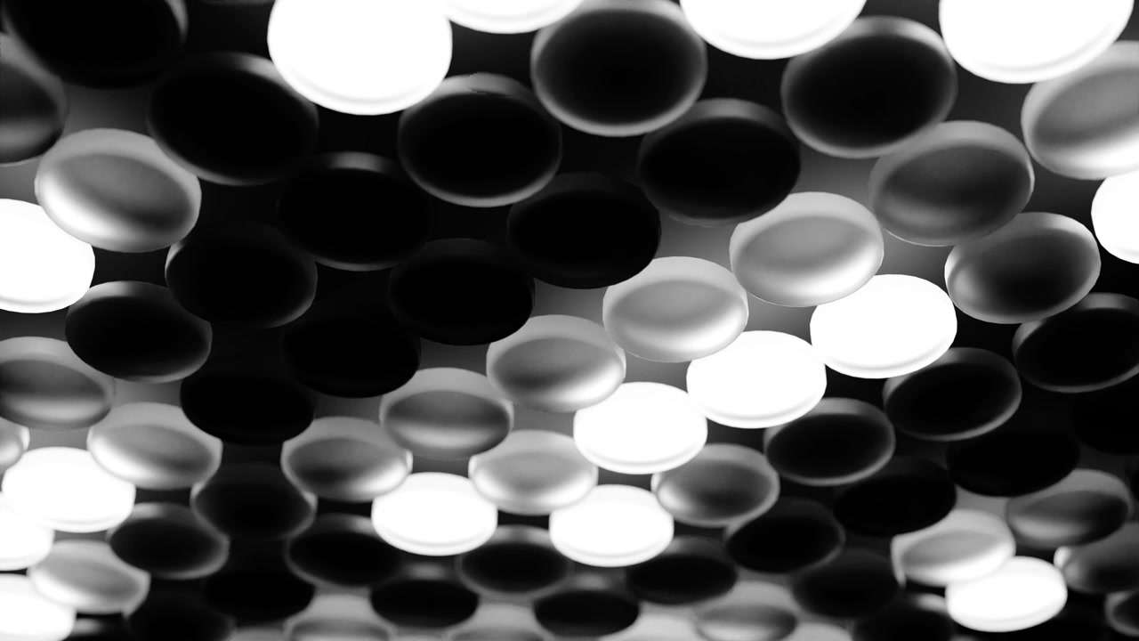 Vista interior abstrata de um teto moderno preenchido com painéis de luz circulares em tons de preto, branco e prata, criando um padrão geométrico ousado com forte contraste.