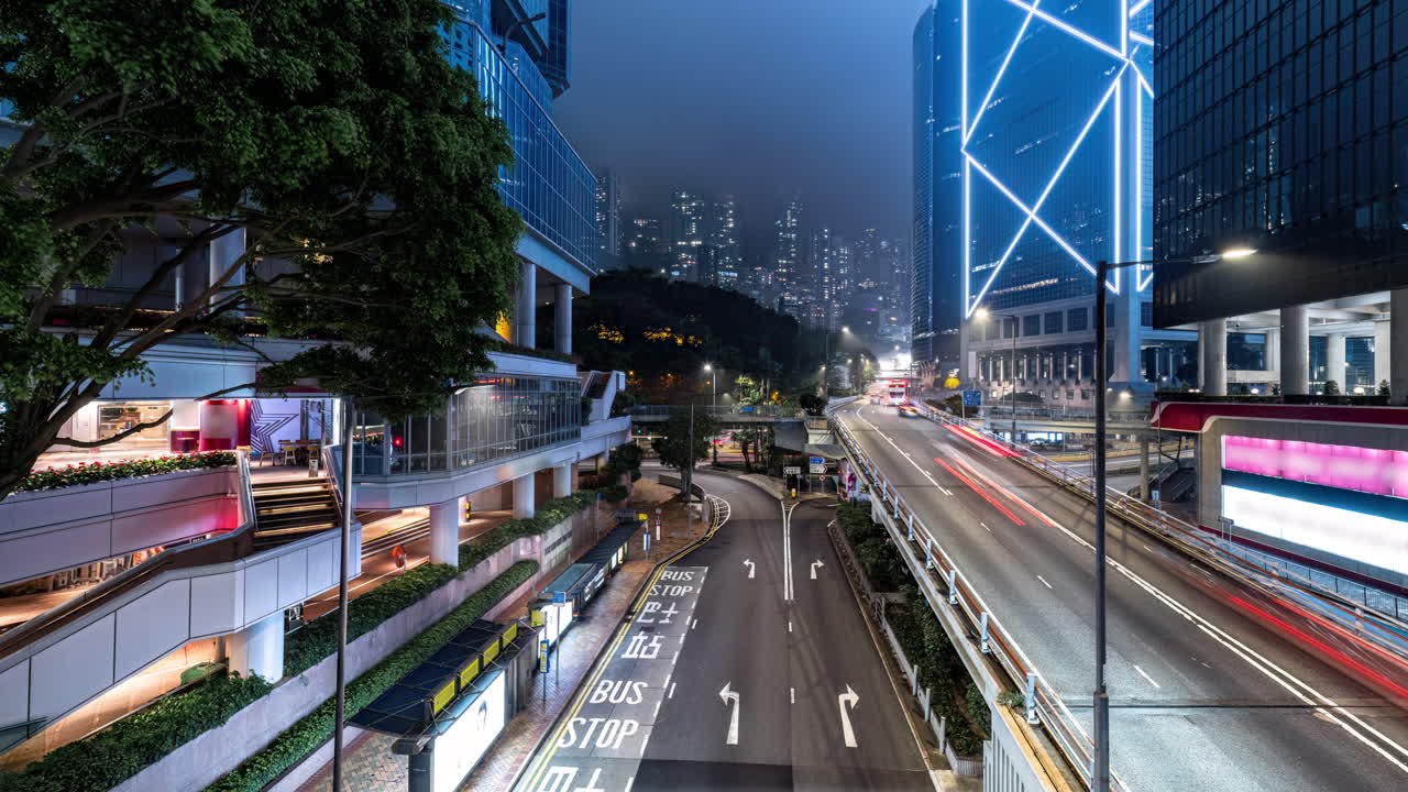 Rainy night time lapse of traffic on South of Cotton Tree Dr in downtown Admiralty Hong Kong