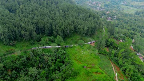 breathtaking aerial drone footage of a train crossing the iconic nine arches bridge in ella, sri lanka.