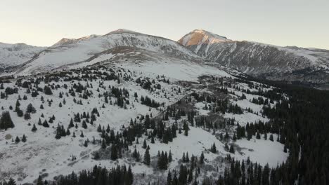 flying over the ridgeline of north star mountain and a trail from highway 9 with mt quandary in the distance