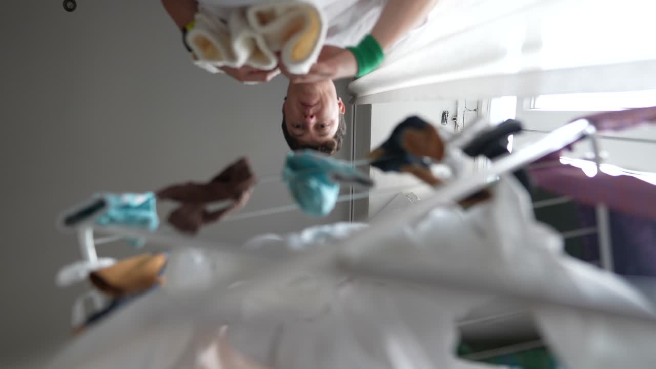 Person hanging clothes to dry