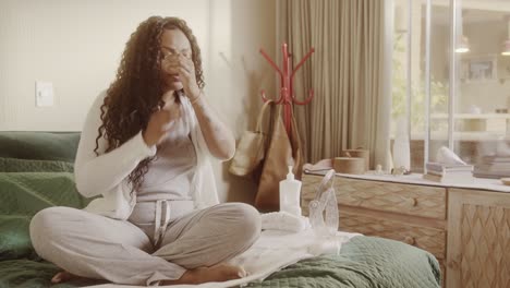 woman's daily skincare routine in a cozy bedroom setting