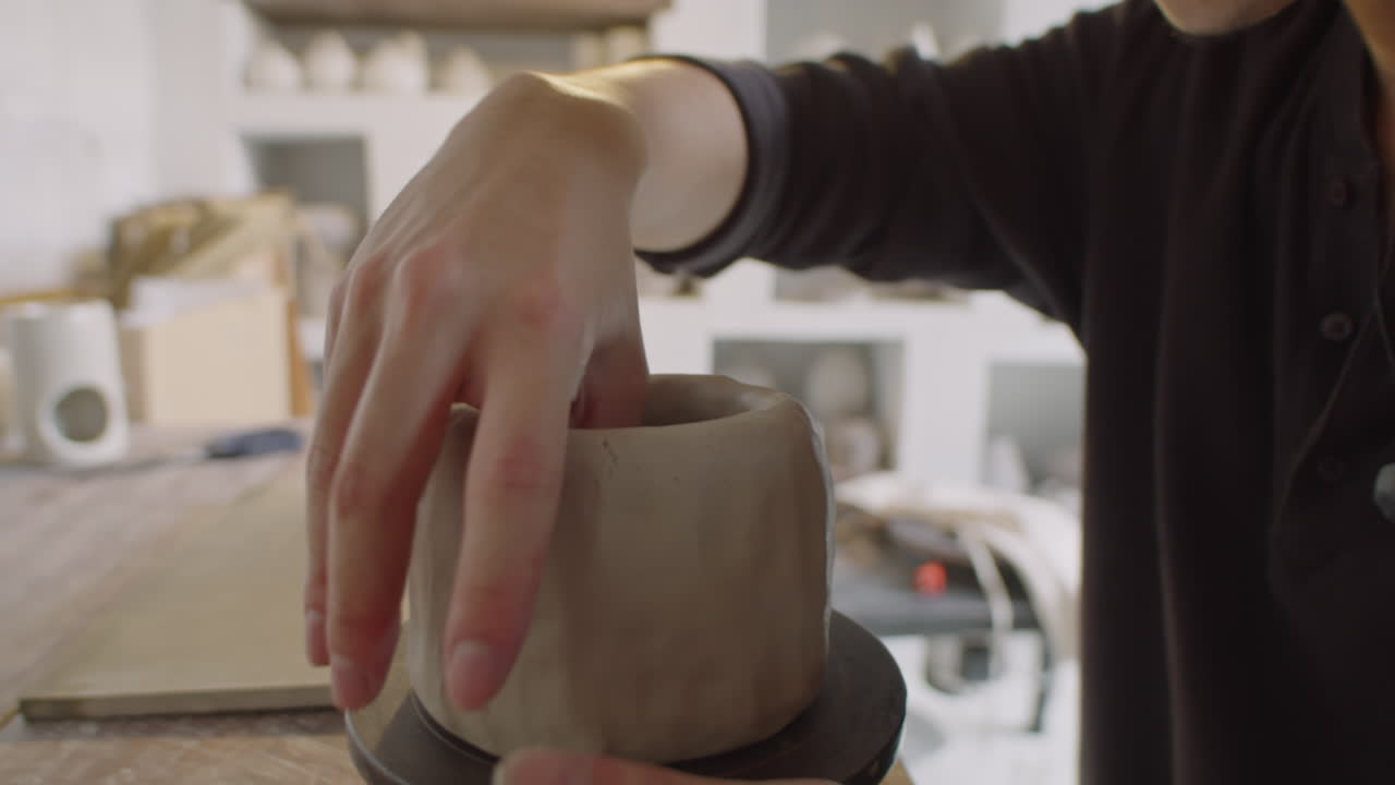 Asian Potter Forming Vase out of Clay on Wheel