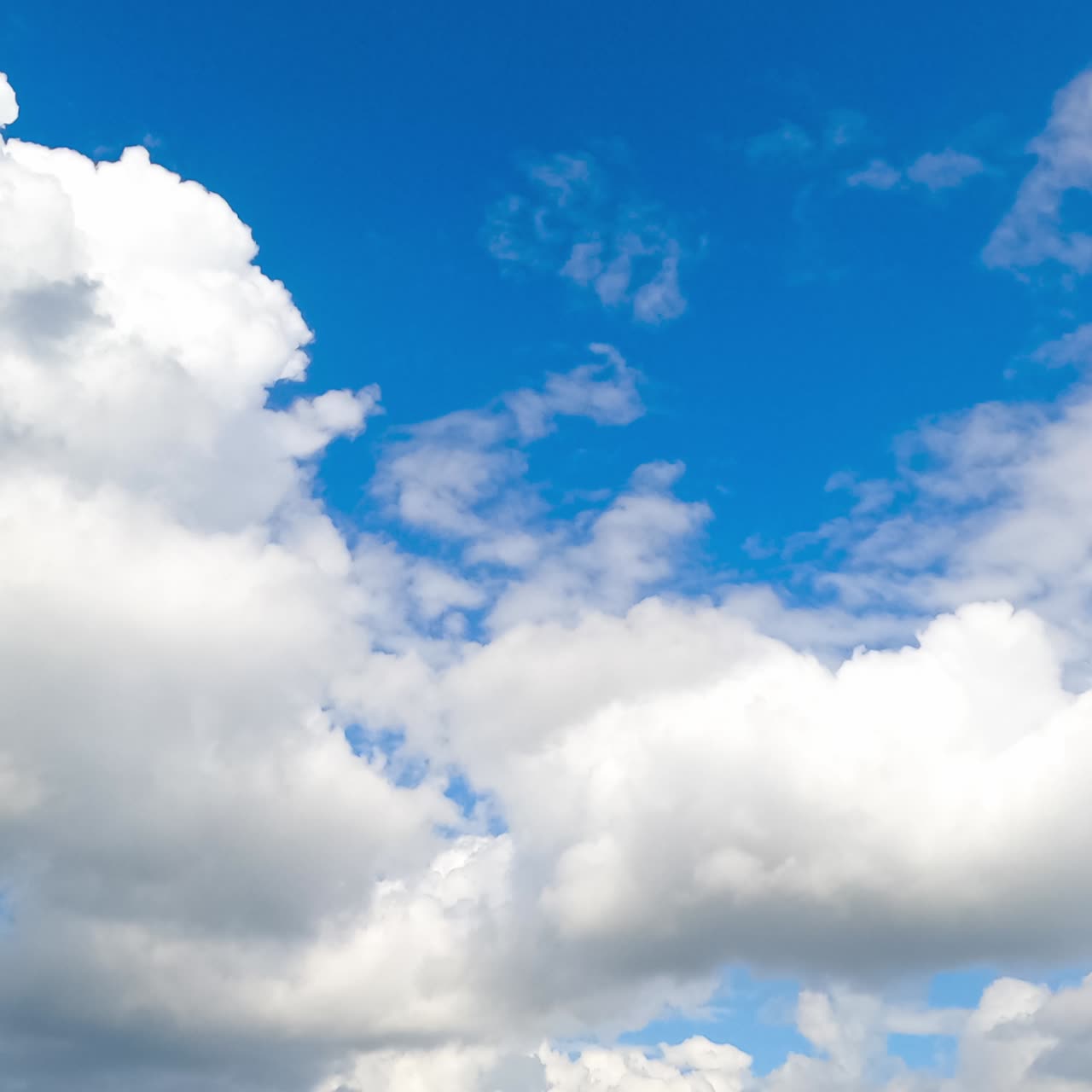 Flying along fluffy soft cotton clouds on beautiful sunny summer day. Heavenly cumulus white clouds movement timelapse