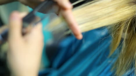 woman cutting her hair in hairdresser salon