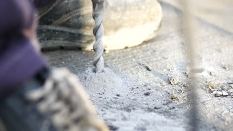 worker drilling a hole in concrete