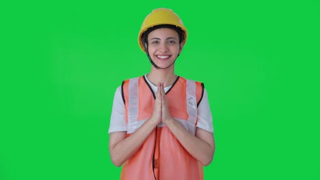 Happy-Indian-female-construction-worker-doing-Namaste-Green-screen