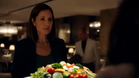 woman serving salad in a restaurant