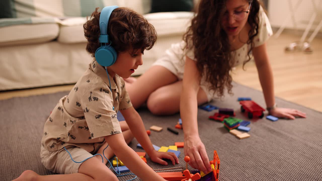 Mother and son playing with toys at home
