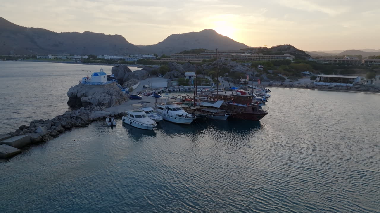 Aerial view of boats at the Kolympia Harbor, sunny evening in Rhodes, Greece
