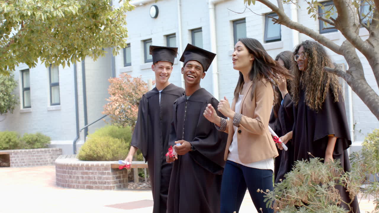 Graduates celebrate outside a high school building, with copy space