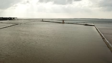 Drone-view-of-windmills-at-Salina-Grande-salt-lakes,-Sicily,-Italy