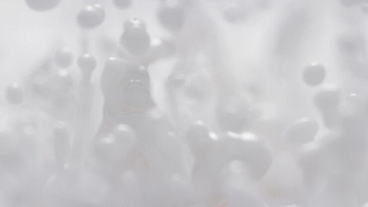 Milk Splashing in Slow Motion and Macro - Abstract White Energetically Bouncing Fluid Makes Droplets and Splashes