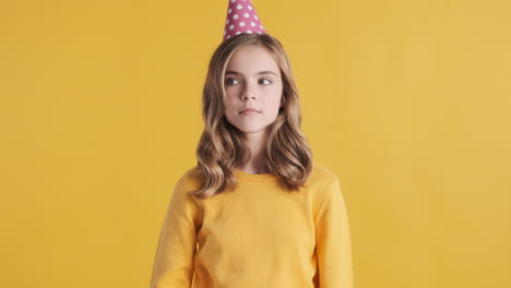 una adolescente caucásica con un sombrero de fiesta.