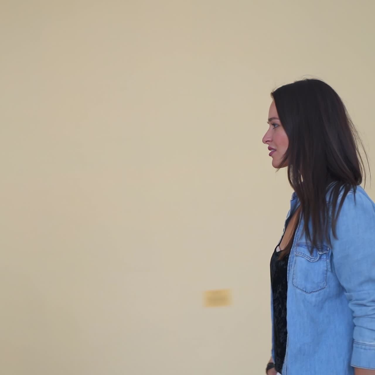 Happy smiling contemporary girl in stylish outfit meets a couple dancing old dance. Lady watching the adult couple in old-fashioned costumes dancing in the castle. Present meeting past