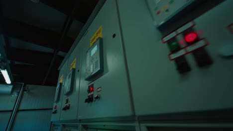 close-up of industrial control panels with illuminated buttons and meters