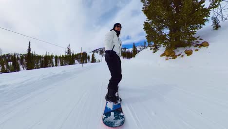 snowboarder rides trails down mountain in colorado