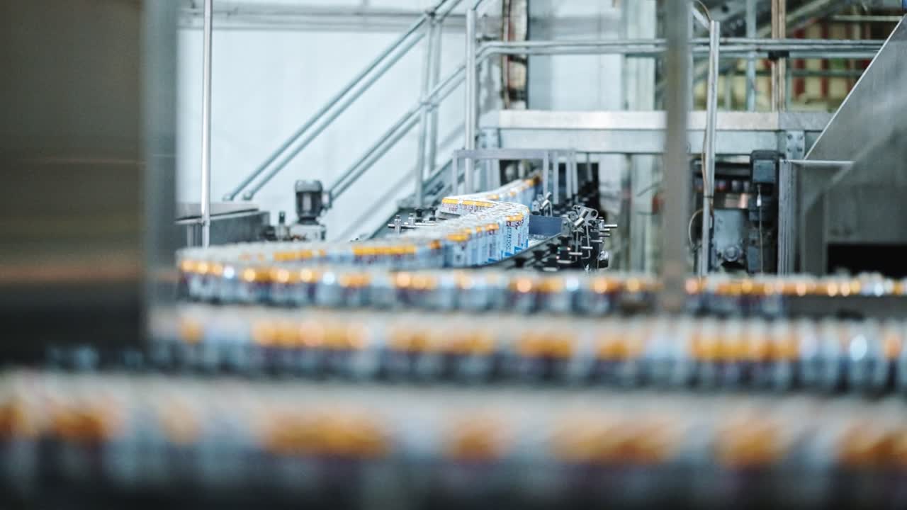 Soda pop beverage cans moving through a factory