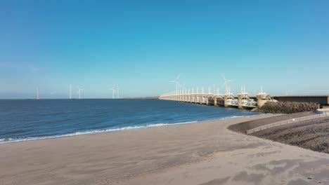 aerial shot of a beach near the eastern scheldt storm surge barrier in zeeland, the netherlands, on a beautiful sunny day