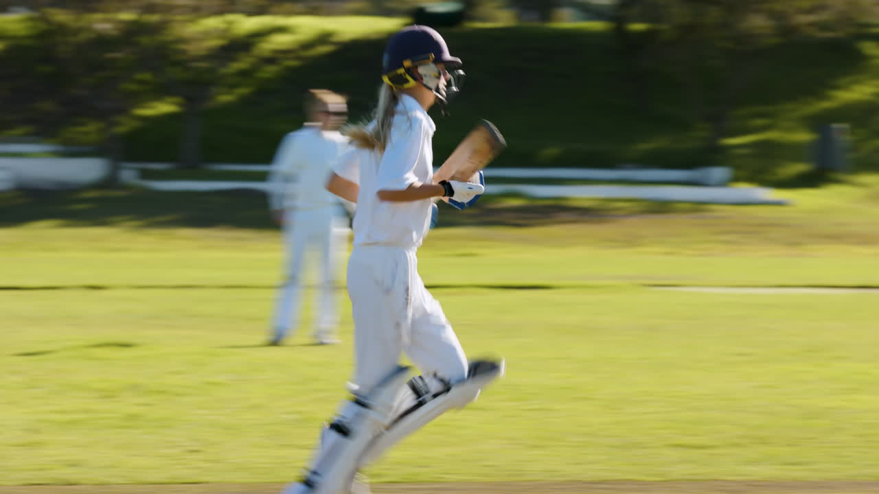 Playing cricket, female athletes walking on field during sunny day match
