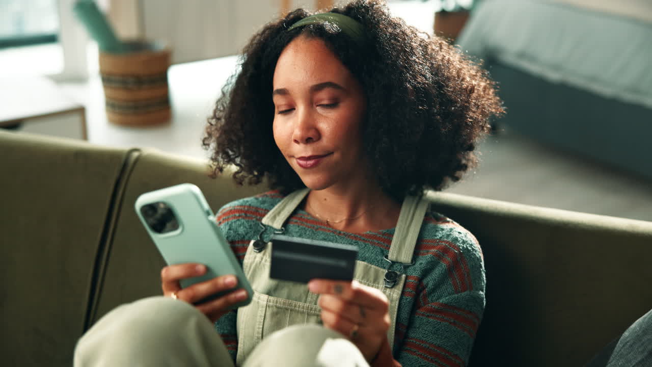 Woman using a phone and credit card