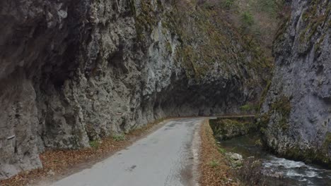 travelling on a scary road in the mountains surrounded by rocks