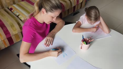 mother and daughter drawing together