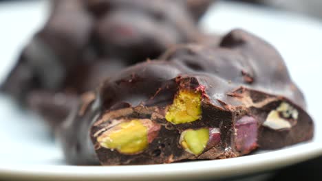 close-up of dark chocolate with pistachios