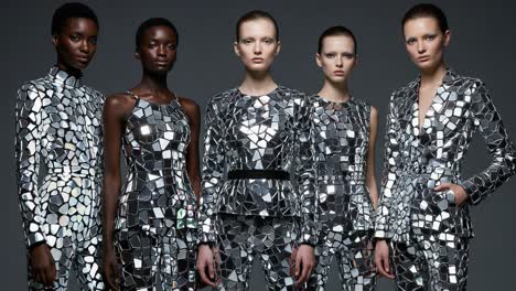 a stunning display of fashion: five models showcase reflective mosaic designs in a stylish photo shoot with unique patterns and textures