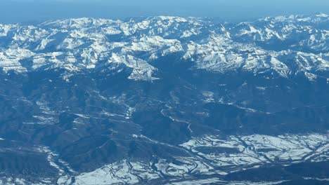 aerial view from a jet cockpit, pilot point of view, of the snowed pyrenees mountains flying from spain to france at 1000m high