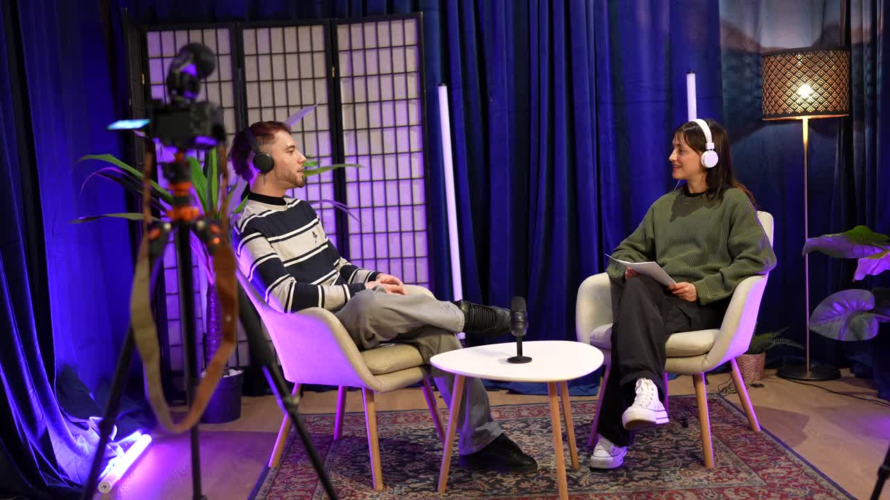 Man and Woman Recording a Podcast Interview in a Modern Studio