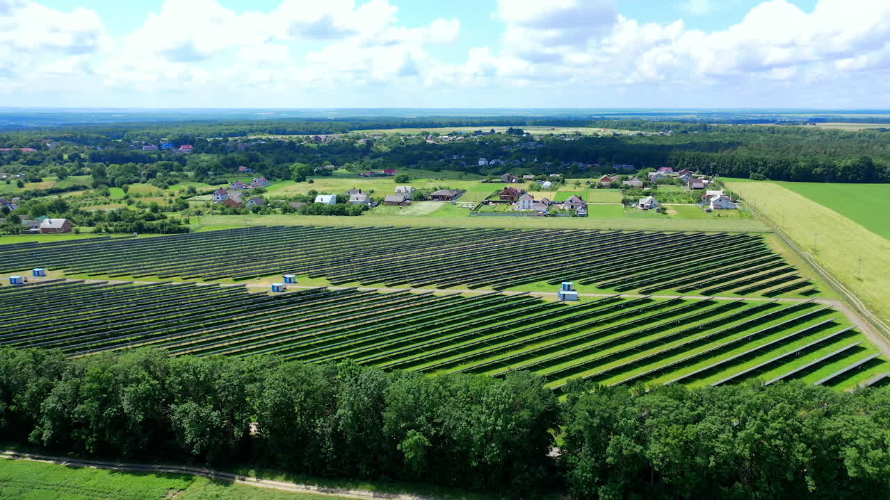 View from the drone of the solar power plant in summer. Innovative solar batteries on the field. Production of clean energy. Ecology concept